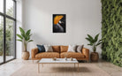 Modern living room with a brown sofa, coffee table, and decorative plants.  With Josie Ryan artwork of crested crane on the wall.